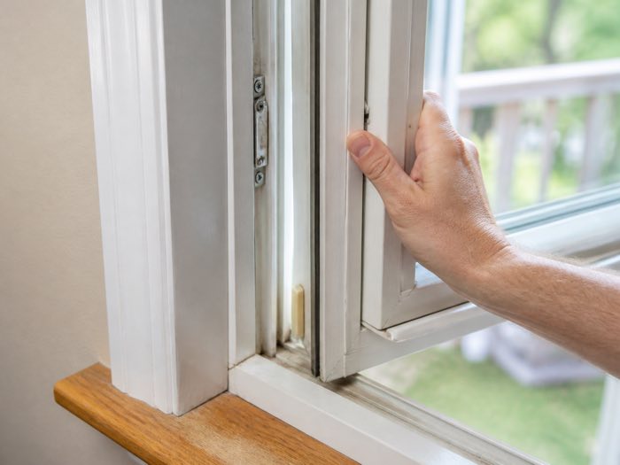 Hand opening a sticking window frame